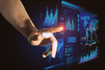 Poster - Close up of man hand pointing at abstract glowing blue business forex chart and map interface on dark background. Trade, finance, analysis, growth, technology and innovation concept.