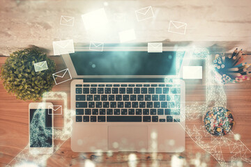 Poster - Envelop hologram drawing over computer on the desktop background. Top view. Double exposure. Technology concept.