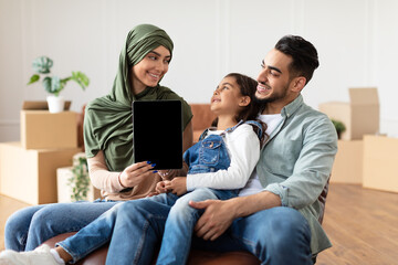 Poster - Happy muslim family doing repair woman showing tablet