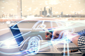 Poster - Double exposure of man's hands holding and using a digital device and automobile theme hologram drawing. Technology concept.