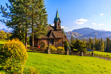 beautiful wooden church plazowka built in traditional style architecture on green meadow with view o