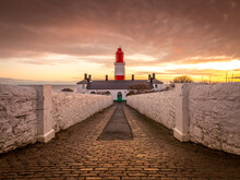The Pathway To The Red And White Striped, 23 Meter Tall,  Souter Lighthouse In Marsden, South Shields As The Sun Rises