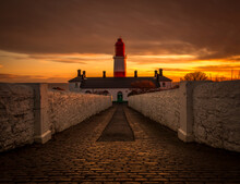 The Red And White Striped, 23 Meter Tall,  Souter Lighthouse And The Leas In Marsden, South Shields, England, As The Sun Rises
