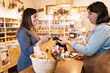 © ADDICTIVE STOCK - Pregnant female paying with smartphone in eco friendly store