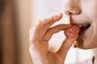 © ADDICTIVE STOCK - Person biting sweet marmalade against blurred background