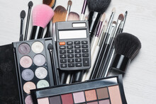 Costs For Beauty And Make Up Concept. Various Makeup Accessories And Products And Calculator.