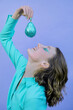 © VISTA by Westend61 - Smiling teenage girl with short hair holding glittered pear over mouth