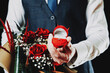 Love propose. Diamond engagement ring, red roses bouquet in young happy man hands. Marriage proposal. Marry me concept.