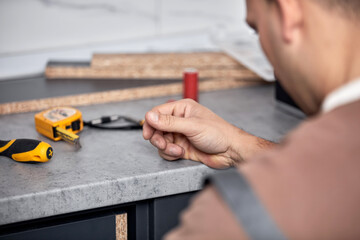 Sticker - Handyman making kitchen wall cabinets in the apartment.