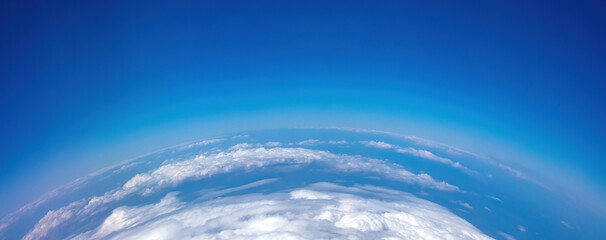 Wall Mural - Curvature of planet earth. Aerial shot. Blue sky and clouds