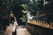 Asian Tourists Are Using The Phone To Take Photos Of The Ancient City Of Chiang Mai, Thailand.