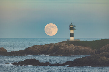 Wall Mural - Full moon on the coast of Galicia, with lighthouse, natural rock arches, etc!