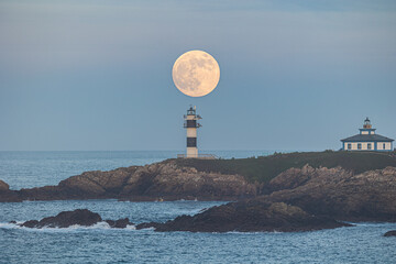 Wall Mural - Full moon on the coast of Galicia, with lighthouse, natural rock arches, etc!