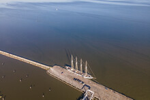 Aerial View Of A Sailing Vessel Anchored At The Pier In Lisbon Harbour Along The Tagus River, Lisbon, Portugal.