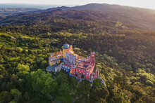Aerial View Of Pena Palace, A Colourful Romanticism Castle Building On Hilltop During A Beautiful Sunset, Sintra, Lisbon, Portugal.