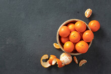 Wooden Bowl Of Tangerine On A Dark Background Top View With Copy Space
