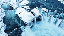 Godafoss aerial shot, famous waterfall in Iceland, Frozen waterfall in winter, a magical winter location of snow and ice, Pure glacial water with a huge current