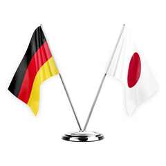 Two table flags isolated on white background 3d illustration, germany and japan