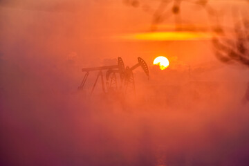 The pumping units in lakeside sunrise, Daqing oil fields Heilongjiang province, China.