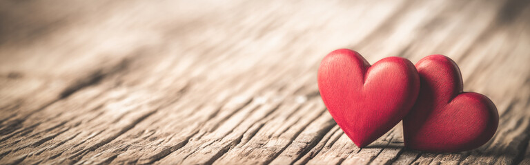 Wall Mural - two red wooden hearts on rustic table with vintage effect - valentine's day