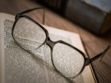 Framed Eyeglasses On Book Page