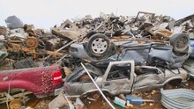 Panning Shot Of Crushed Cars And Scrap Metal