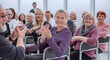 © ASDF - a group of elderly people are sitting in a circle clapping their hands. applause