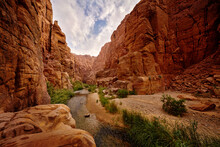 Wadi Mujib Biosphere Reserve, Red Rock Ravine Gorge With River. Jordan Water Stream With Blue Sky. Wadi Mujib Lowest Nature Reserve Landscape, With A Spectacular Array Of Scenery Near Dead Sea.