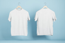 Empty White T-shirts On Blue Wall Background, Product Design And Presentation Concept. Mock Up Logo. 3D Rendering.