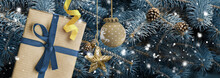 New Year And Christmas Background. Present On Blue Christmas Tree With Baubles