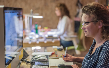 business woman accountant designer works on computer in working office