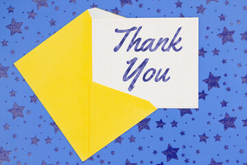 Wall Mural - Thank you greeting card with yellow envelope on stars