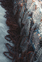 Vertical View Of Various Metal Fishing Traps And Scattered Ropes. Close-up View Of Crab Cage Stacked On The Floor Of A Fishing Pier. Stack Lobster Or Crab Traps And Braided Ropes On The Dock