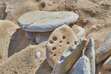 
used stones on a sandy beach