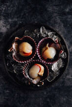 Delicious Scallops Served On Shells Against Dark Table