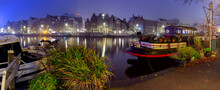 Panorama Of The City Waterfront Of Amsterdam On A Foggy Morning.