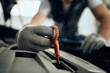 © Drazen - Close-up of mechanic examines car oil in auto repair shop.