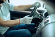 © Drazen - Close-up of car mechanic behind steering wheel at service workshop.