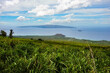 The island of Lanai in the Distance from Maui, Hawaii with sugar cane fields in the foreground. 