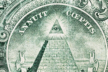 Close up of the Eye of Providence on a old worn US one dollar bill.