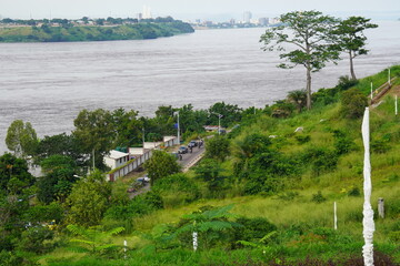 Kinshasa - February 6, 2021: Traffic on Avenue des touristes in Ngaliema, Kinshasa, CD. Congo River and Brazzaville (in background) seen from Mount Ngaliema, Kinshasa.