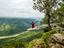 Happy Man Sitting On The Overhanging Leopard Rock In Port Shepstone South Africa