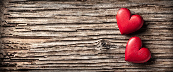 Wall Mural - two red wooden hearts on rustic table background - valentine's day