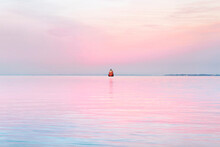 Pink Sunset On Chesapeake Bay With Red Lighthouse In Maryland Us