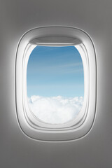 looking through a big jet passenger plane window, above the clouds