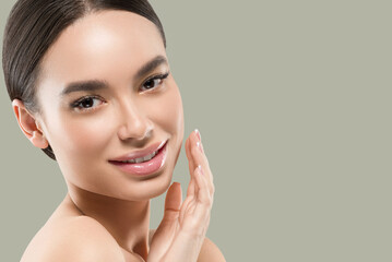 asia woman beauty face body portrait touching her face healthy skin. color background. green