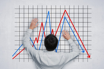 Wall Mural - Back view of business man with abstract downward falling into hole business chart with arrow sketch on concrete wall background. Finance, crisis and down concept.