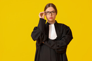 Wall Mural - Young female judge on color background