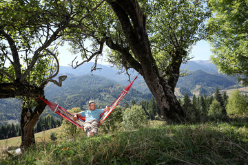 Sticker - Man resting in hammock outdoors on sunny day