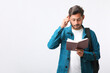 © PRASANNAPIX - Young Indian college student holding diary in hand on white background.
